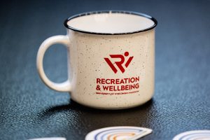 a mug with the Recreation & Wellbeing logo
