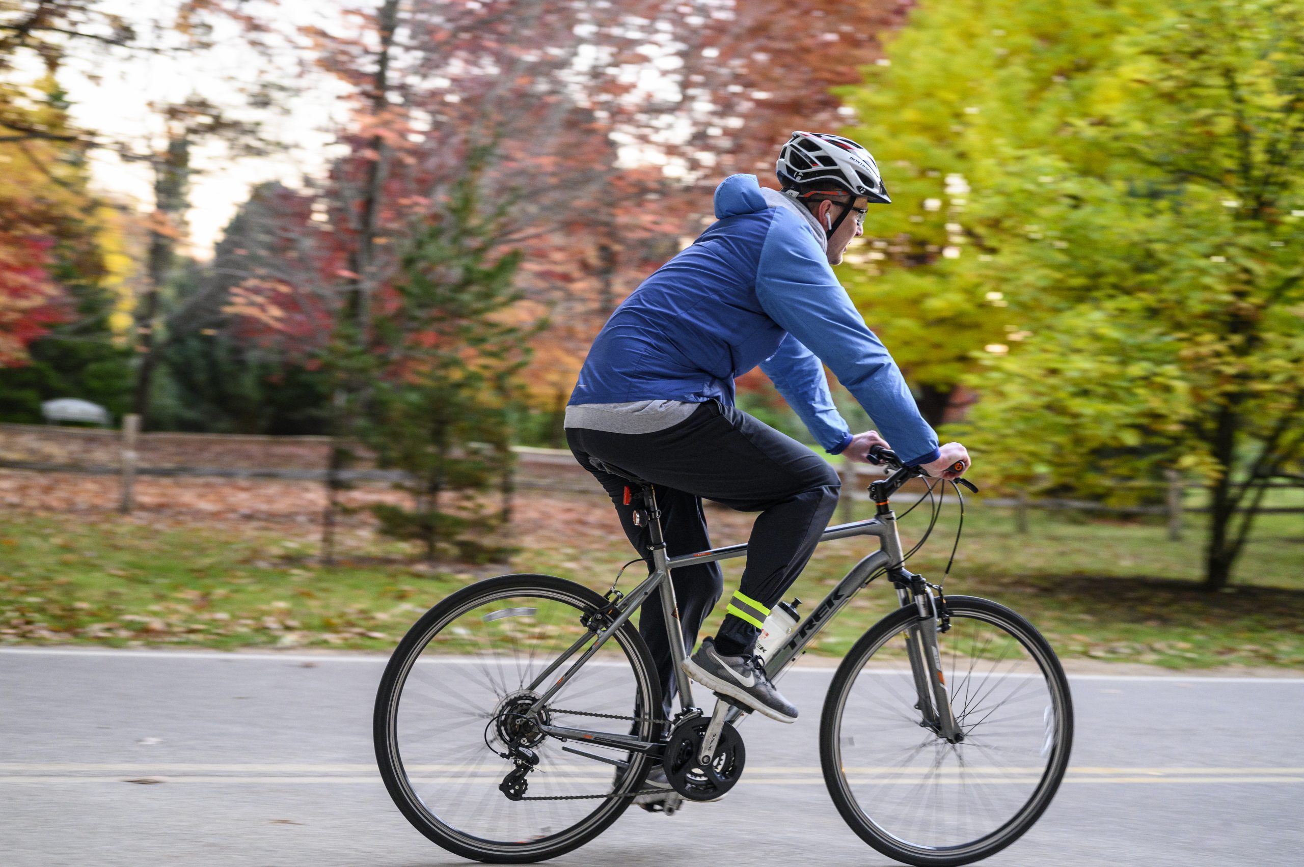 a cyclist bikes through a fall landscape