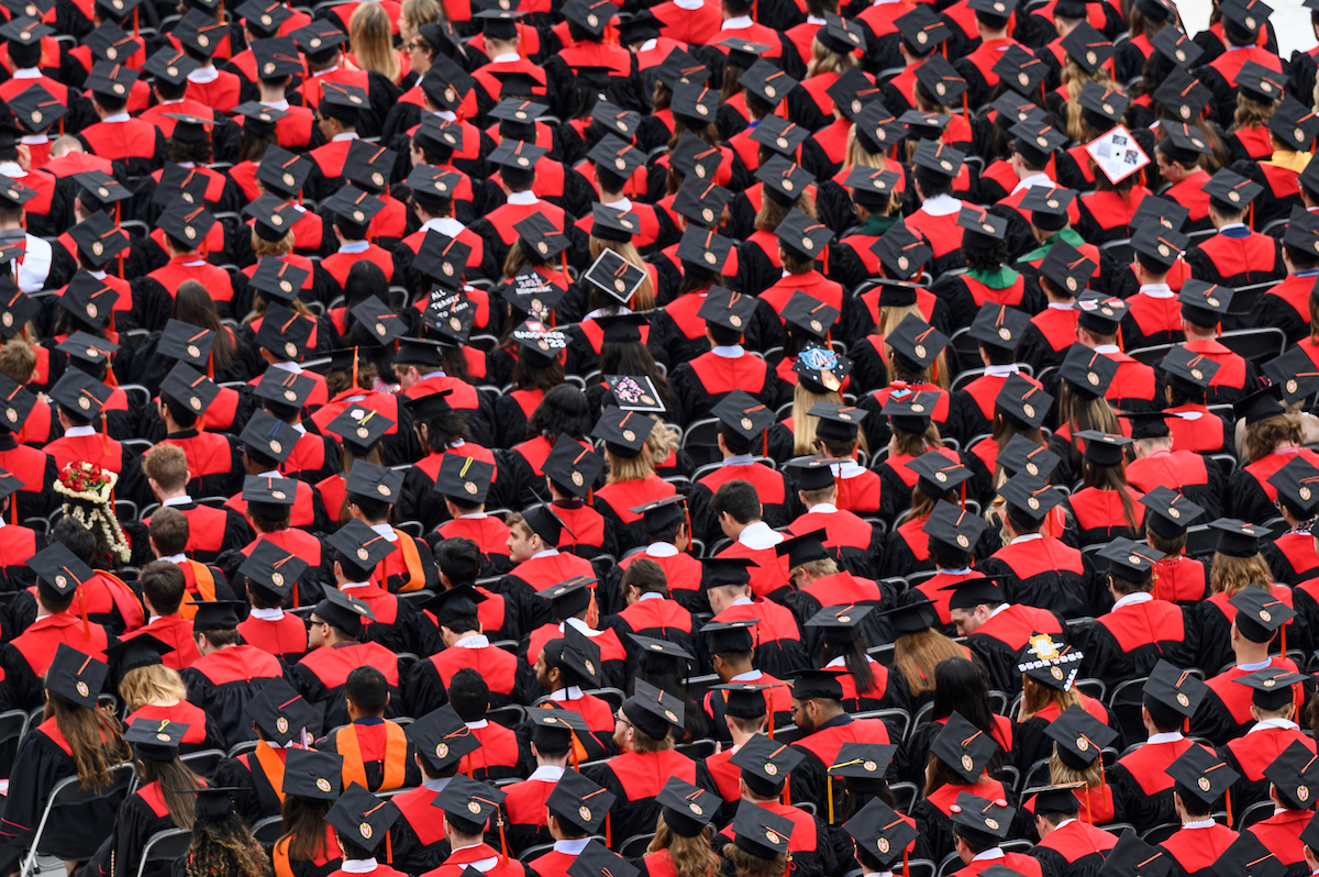 a sea of graduates in their caps and robes